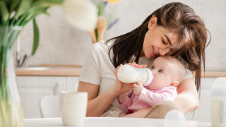 Mutter füttert Baby mit dem Fläschchen
