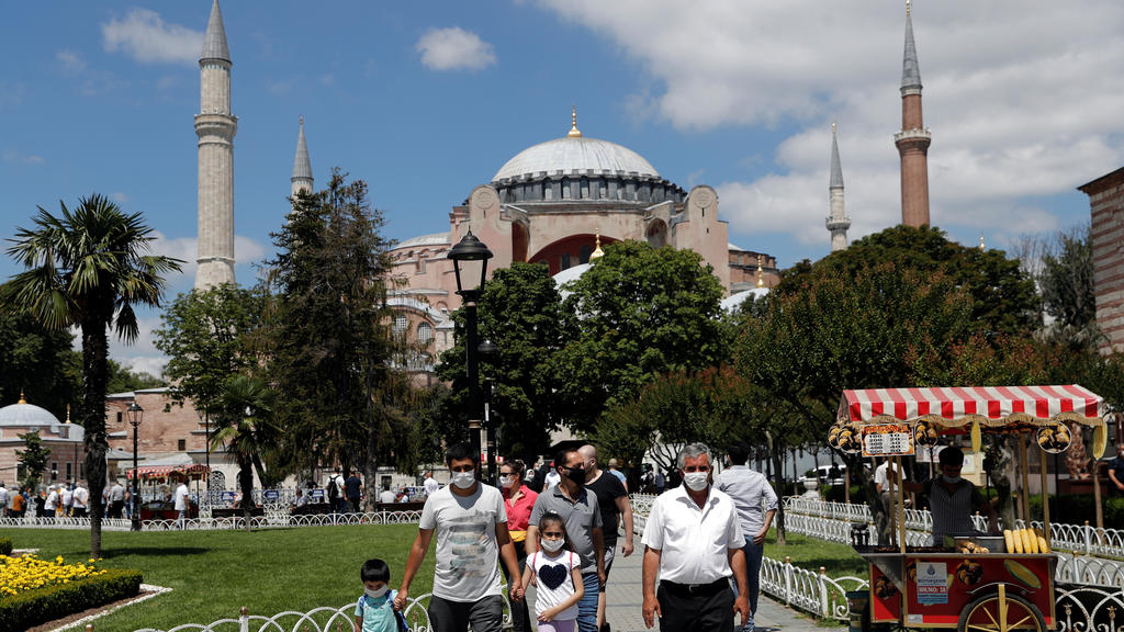 People stroll at Sultanahmet Square near Hagia Sophia, or Ayasofya-i Kebir Camii, in Istanbul, Turkey, July 11, 2020. REUTERS/Murad Sezer