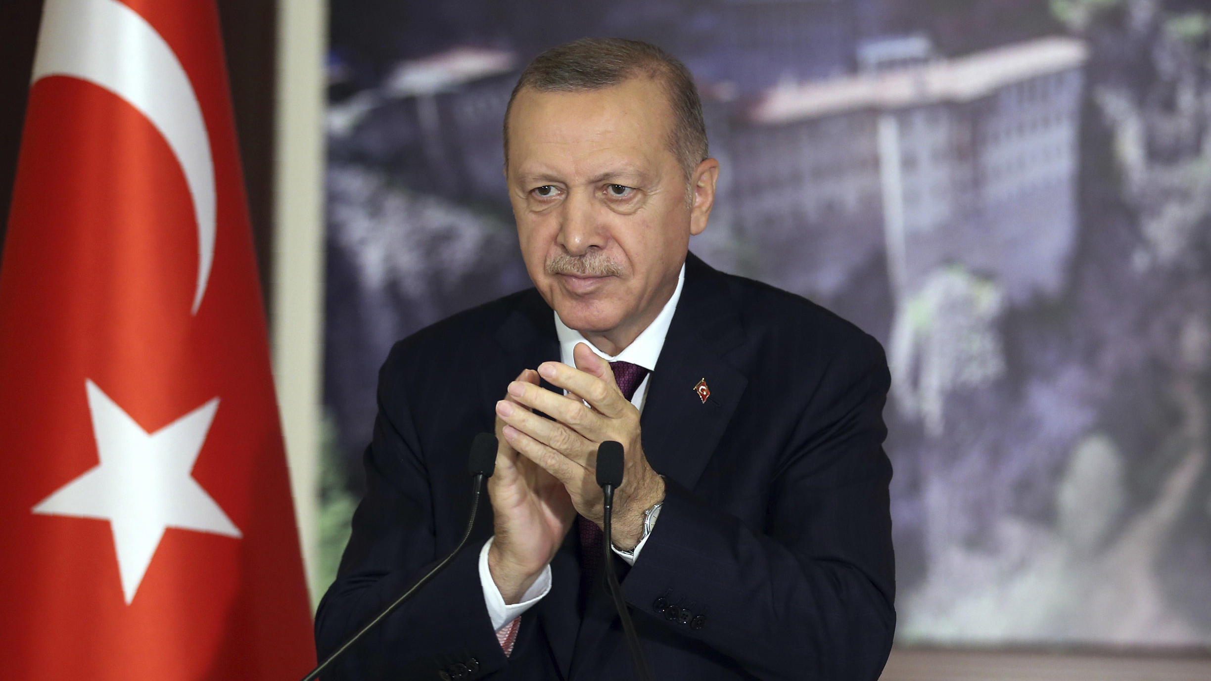 Turkey's President Recep Tayyip Erdogan applauds during a conference in Istanbul, Tuesday, July 28, 2020. Turkish lawmakers were making their final speeches Tuesday before voting on a bill that would give the government greater powers to regulate soc