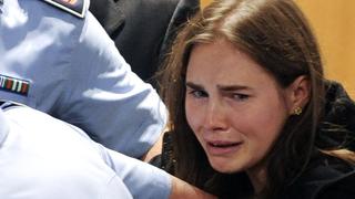 Amanda Knox of the U.S. reacts after the verdict on Knox and Raffaele Sollecito of Italy in the killing of British student Meredith Kercher was announced at a court in Perugia October 3, 2011. The Italian court cleared Knox, a 24-year-old Seattle native, and Sollecito, Knox's former boyfriend, of the 2007 killing of Kercher and ordered they be freed on Monday after nearly four years in prison for a crime they always denied committing. The verdict came after independent forensic investigators sharply criticised police scientific evidence in the original investigation, saying it was unreliable. REUTERS/Tiziana Fabi/Pool (ITALY - Tags: CRIME LAW TPX IMAGES OF THE DAY)