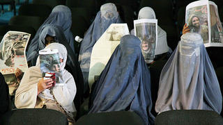 Afghan women cover their faces as they wait for the ceremony to mark the ninth death anniversary of assassinated anti-Taliban Afghan rebel leader Ahmad Shah Masood, in Kabul, Afghanistan, on 08 September 2010. Ahmed Masood was the victim of a suicide attack in Khvajeh Ba Odin 09 September 2001, two days before the September 11, 2001 terrorist attacks in the United States, a timing considered significant by some commentators who believe Osama bin Laden ordered the assassination to ensure he would have the Taliban's protection and cooperation in Afghanistan. Photo: S. Sabawoon/EPA  +++(c) dpa - Bildfunk+++