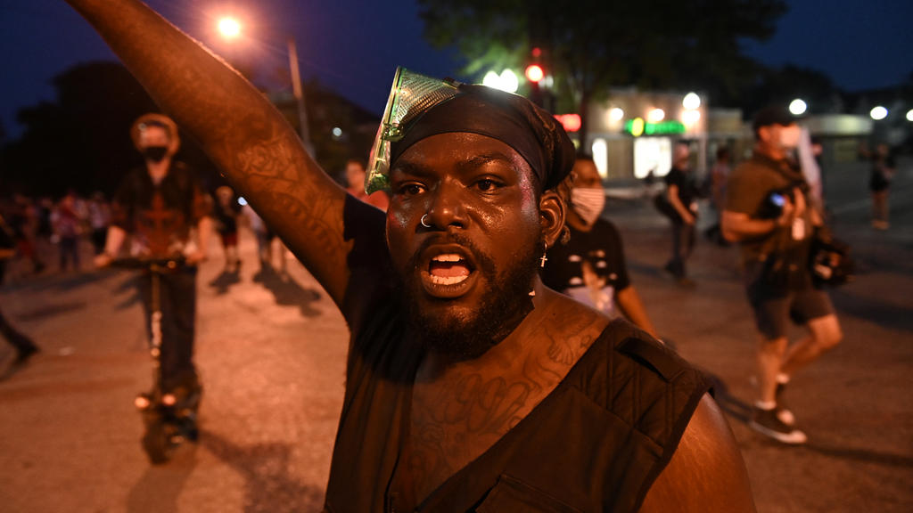 A demonstrator takes part in a protest following the police shooting of Jacob Blake, a Black man, in Kenosha, Wisconsin, U.S. August 26, 2020.   REUTERS/Stephen Maturen