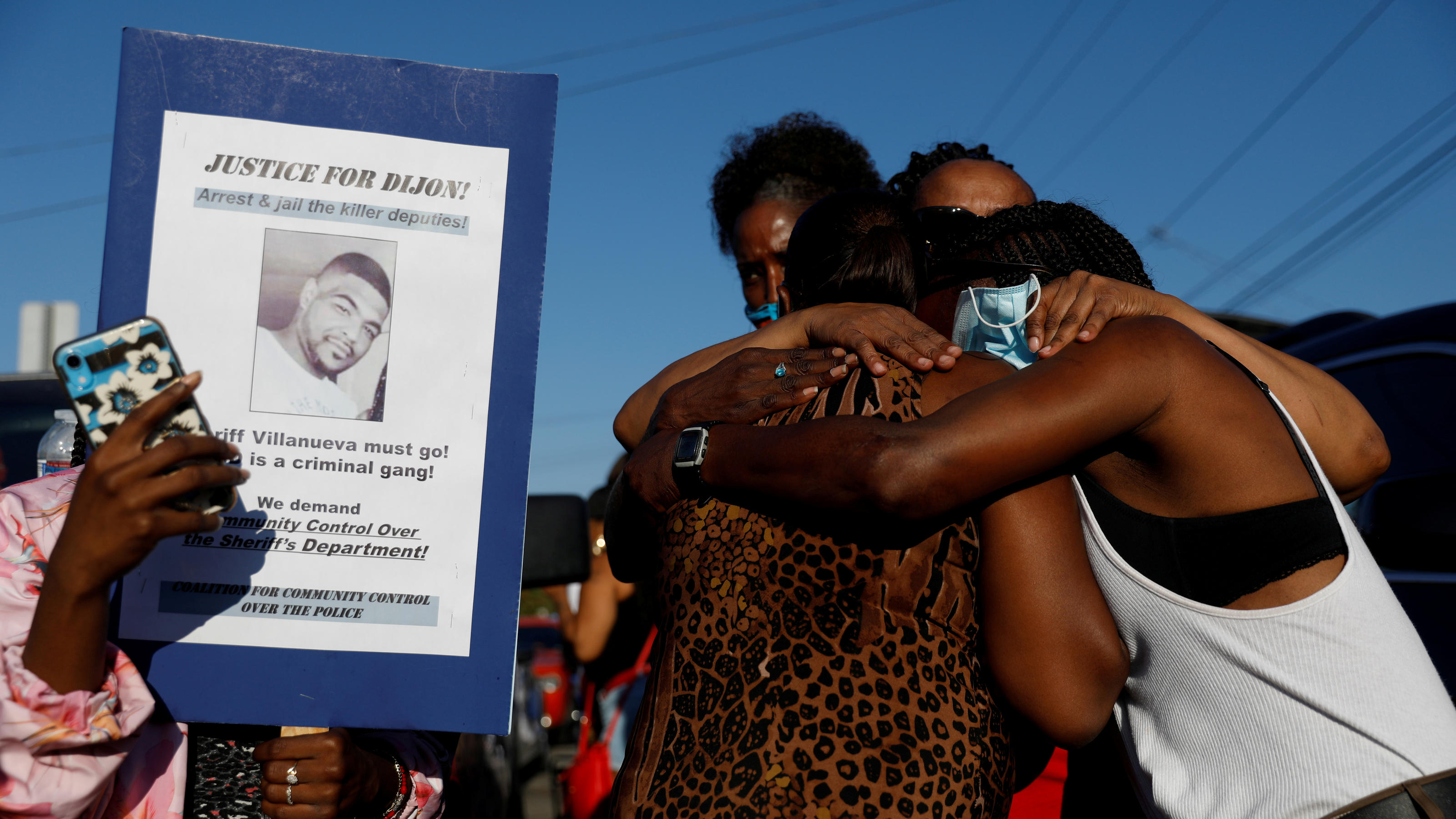 Debra Ray, aunt of Dijon Kizzee, is embraced by family members as people protest against the shooting of Dijon Kizzee by Los Angeles sheriff's deputies, in Los Angeles, California, U.S., September 1, 2020. REUTERS/Patrick T. Fallon