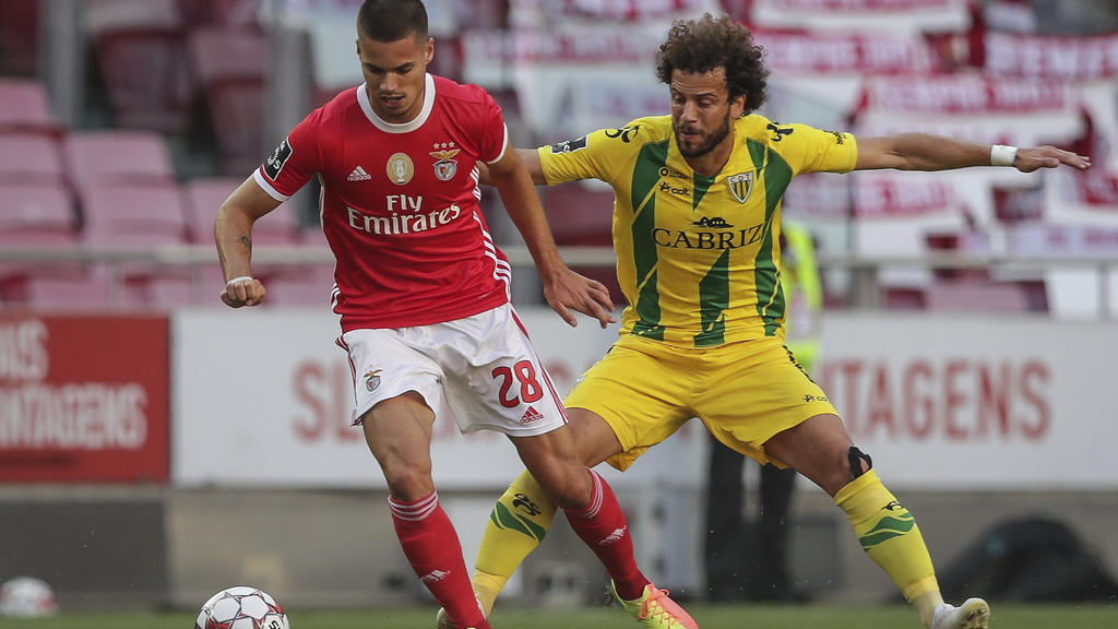 Benfica's player Julian Weigl, left, vies for the ball with Tondela's Joao Pedro during a Portuguese League soccer match between Benfica and Tondela in Lisbon, Portugal, Thursday, June 4, 2020. The Portuguese League soccer matches resumed Wednesday w