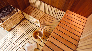 Interior of a wooden sauna room,with towels,bucket and ladle, view from the top