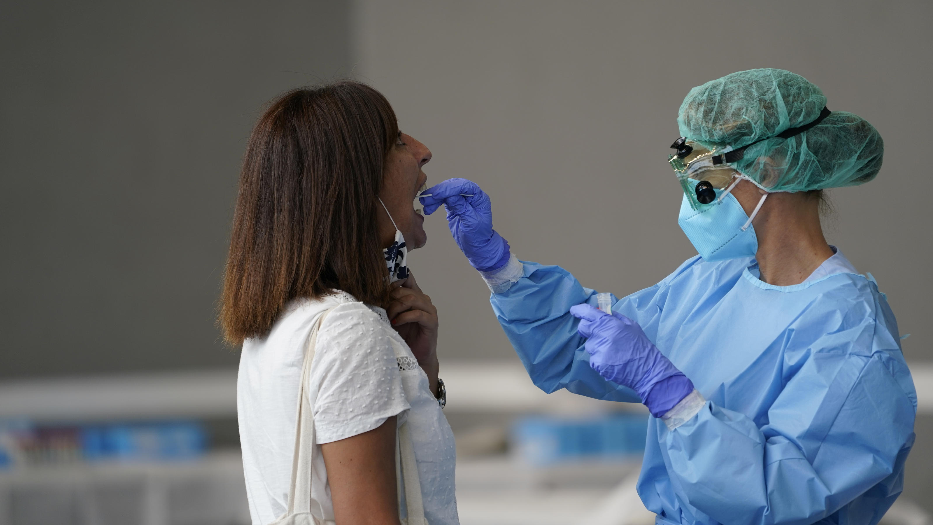 A medical worker administers a PCR test to a resident of the Basque town of Azpeitia, Spain, amid a localised outbreak of the coronavirus disease (COVID-19), August 17, 2020. REUTERS/Vincent West