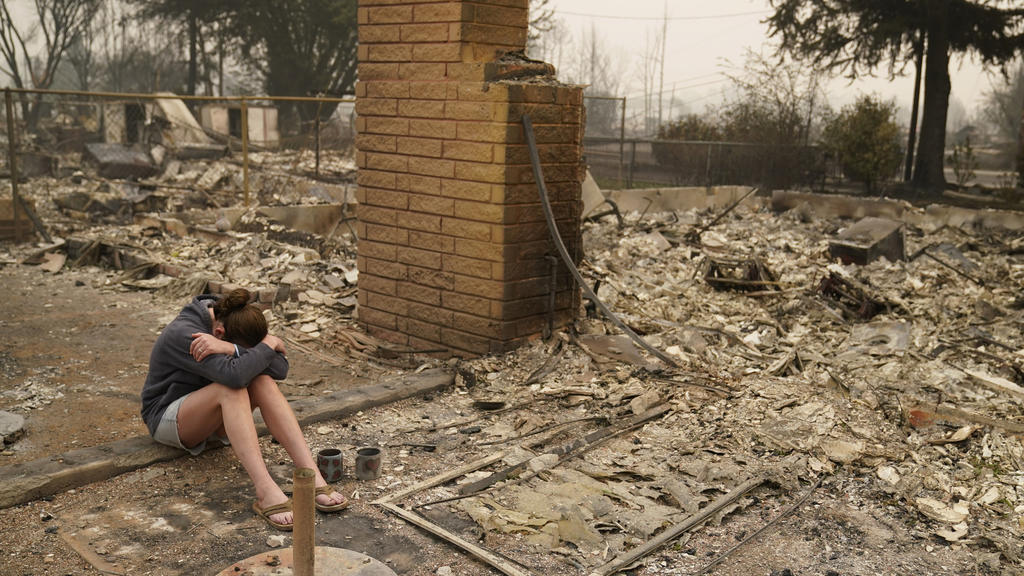 11.09.2020, USA, Talent: Desiree Pierce sitzt weinend in den Trümmern ihres Hauses, das bei den verheerenden Waldbränden in den USA durch das sogenannte Almeda-Feuer zerstört wurde. Im US-Bundesstaat Oregon sollen zuletzt mehr als 40 Brände gelodert