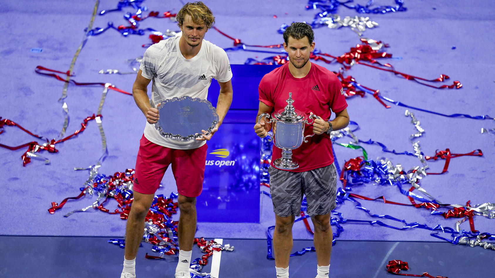 Dominic Thiem, of Austria, and Alexander Zverev, of Germany, pose for photos after the men's singles final of the US Open tennis championships, Sunday, Sept. 13, 2020, in New York. Thiem defeated Zverev in a tiebreaker. (AP Photo/Seth Wenig)