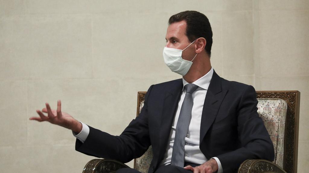 FILE - In this Monday, Sept. 7, 2020 file photo released by Russian Foreign Ministry Press Service, Syrian President Bashar al-Assad gestures while speaking to Russian Foreign Minister Sergey Lavrov during their talks in Damascus, Syria. U.N.-backed