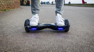 London, England - December 28, 2015: Person Riding a HoverBoard on a Public Footpath, They are now banned in all public places in the United 