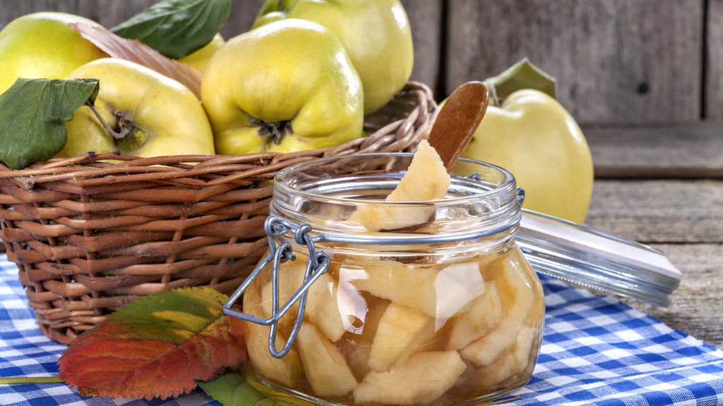 canned fresh and healthy quince on an old wooden table