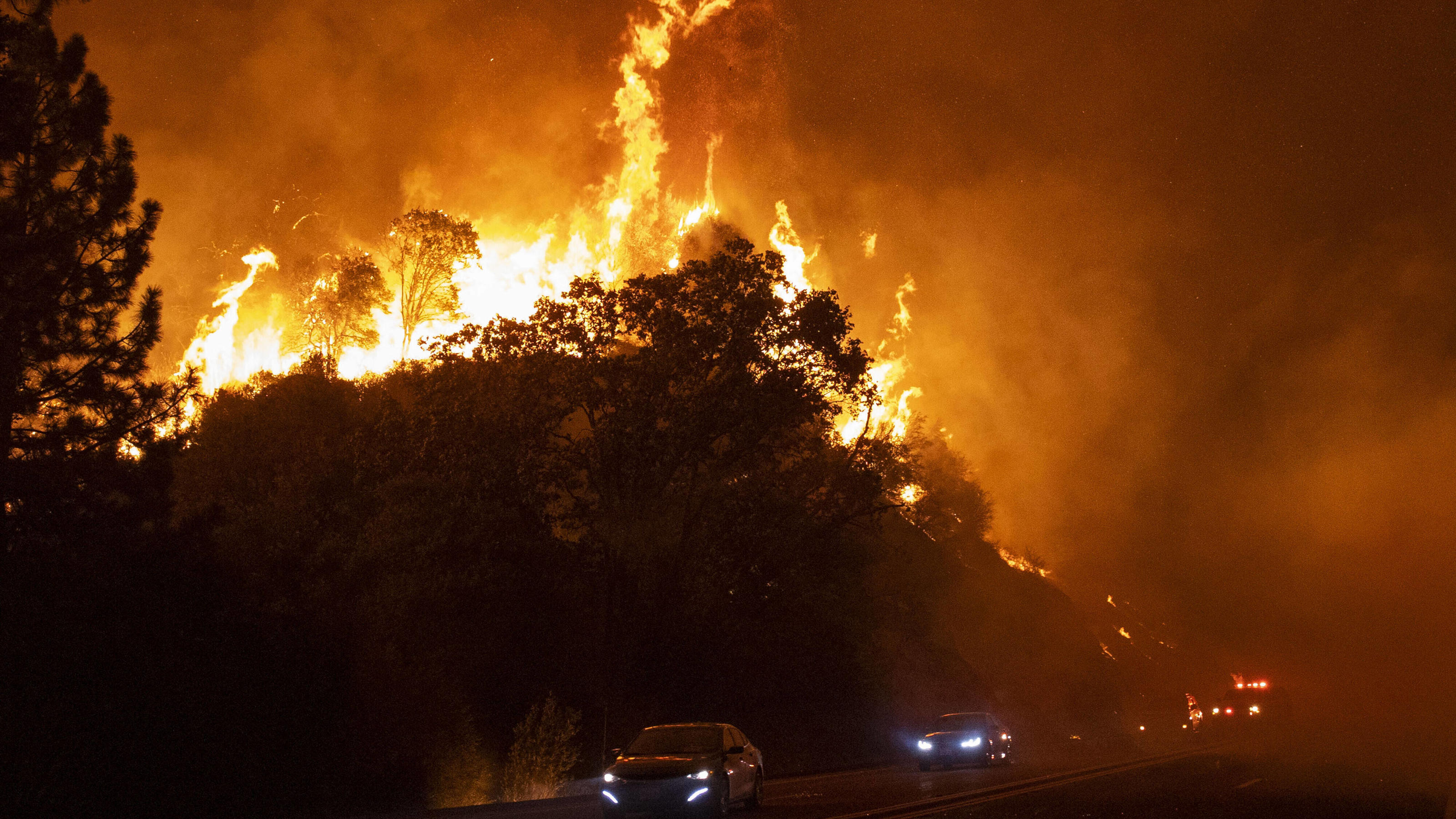  High winds blow embers and flames across Hwy 168 as the Creek Fire rapidly expands on September 8, 2020 near Shaver Lake, California. California Gov. Gavin Newsom declared a state of emergency in five California counties late yesterday as record hea
