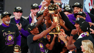 Oct 11, 2020; Lake Buena Vista, Florida, USA; The Los Angeles Lakers hold up the Finals trophy after game six of the 2020 NBA Finals at AdventHealth Arena. The Los Angeles Lakers won 106-93 to win the series. Mandatory Credit: Kim Klement-USA TODAY Sports