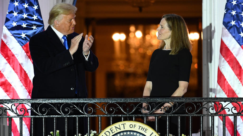 President Donald Trump applauds Judge Amy Coney Barrett after she took her Constitutional oath to become a Supreme Court justice, at the White House in Washington, DC on Monday, October 26, 2020. Earlier today Barrett was confirmed by the Senate, 52
