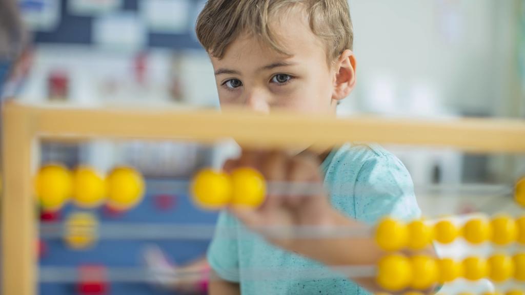 Boy in kindergarten using abacus model released Symbolfoto property released PUBLICATIONxINxGERxSUIxAUTxHUNxONLY ZEF15446