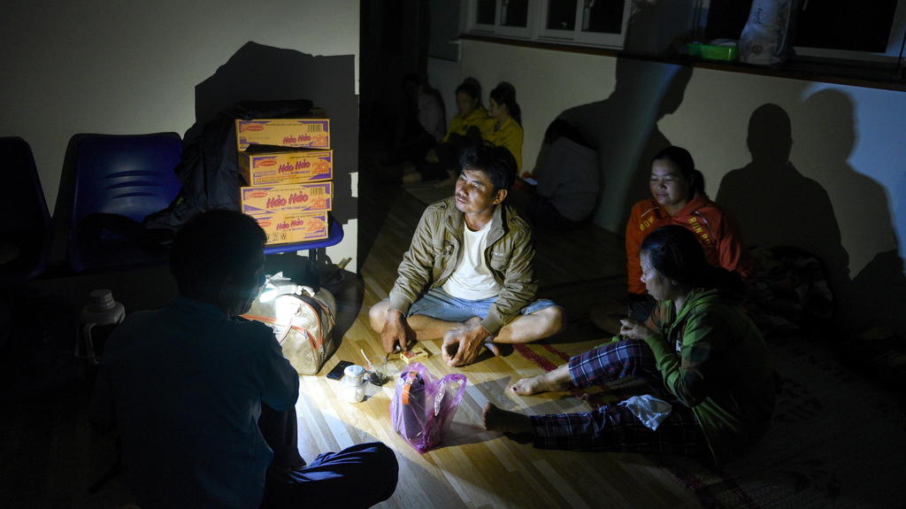 Family waits in a shelter as Typhoon Molave lashes Vietnam's coast in Binh Chau village, Quang Ngai province October 28, 2020. REUTERS/Thanh Hue NO RESALES. NO ARCHIVES