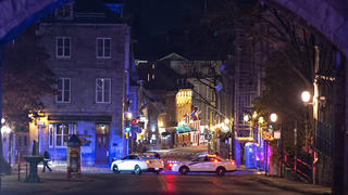 Police cars block the Saint-Louis Street near the Chateau Frontenac early Sunday, Nov. 1, 2020 in Quebec City, Canada. Police in Quebec City early Sunday arrested a man on suspicion of killing two people and injuring five others in a stabbing rampage near the provincial legislature on Halloween. (Jacques Boissinot/The Canadian Press via AP)