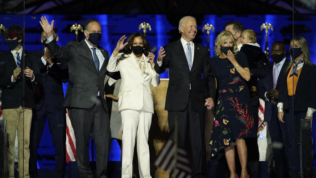 From left, Doug Emhoff, husband of Vice President-elect Kamala Harris, Harris, President-elect Joe Biden and his wife Jill Biden on stage together, Saturday, Nov. 7, 2020, in Wilmington, Del.(AP Photo/Andrew Harnik, Pool)