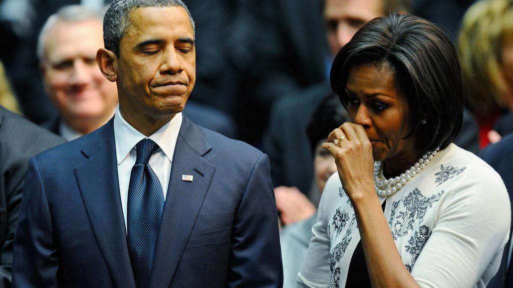 President Barack Obama L comforts his wife first lady Michelle Obama after his speech at the event Together We Thrive: Tucson and America honoring the January 8 shooting victims at McKale Memorial Center on the University of Arizona campus on Januar