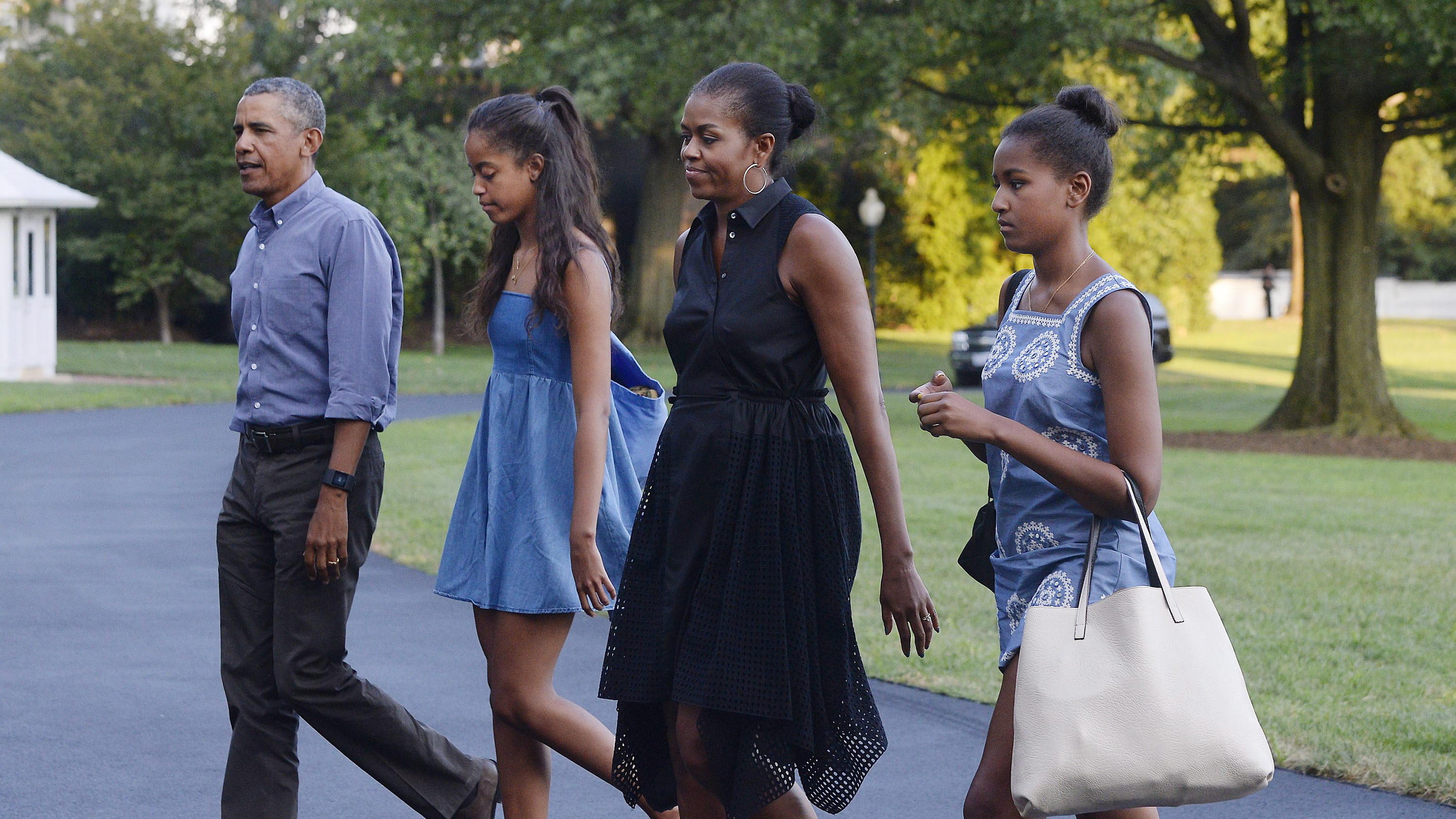 ARCHIV - 23.08.2015, USA, Washington: Barack Obama (l), ehemaliger US-Präsident, Ehefrau Michelle (2.v.r) und die Töchter, Sasha (2.v.l), und Malia (r), treffen im Weißen Haus ein, nachdem sie von ihrem Urlaub in Martha's Vineyard zurückgekehrt sind.