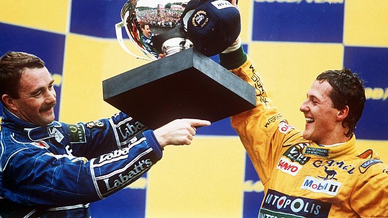 ARCHIV - Der deutsche Formel-1-Rennfahrer Michael Schumacher (r) vom Team Benetton-Ford und der Brite Nigel Mansell, der Zweiter wurde, mit dem Siegerpokal in Spa in Belgien (Archivfoto vom 30.08.1992). Mit seinem ersten Grand Prix-Sieg krönte Schuma