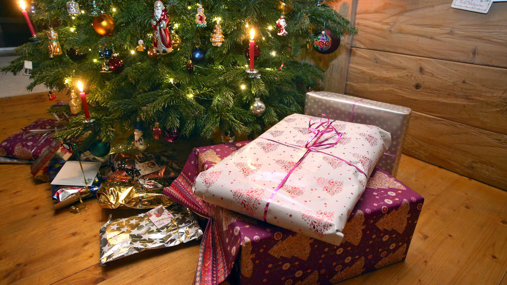 Weihnachtsgeschenke liegen unter einem geschmücktem Christbaum. Die Verbraucher in Deutschland kaufen laut einer aktuellen Umfrage ihre Weihnachtsgeschenke immer öfter im Internet. (zu dpa «Umfrage: Deutsche k
