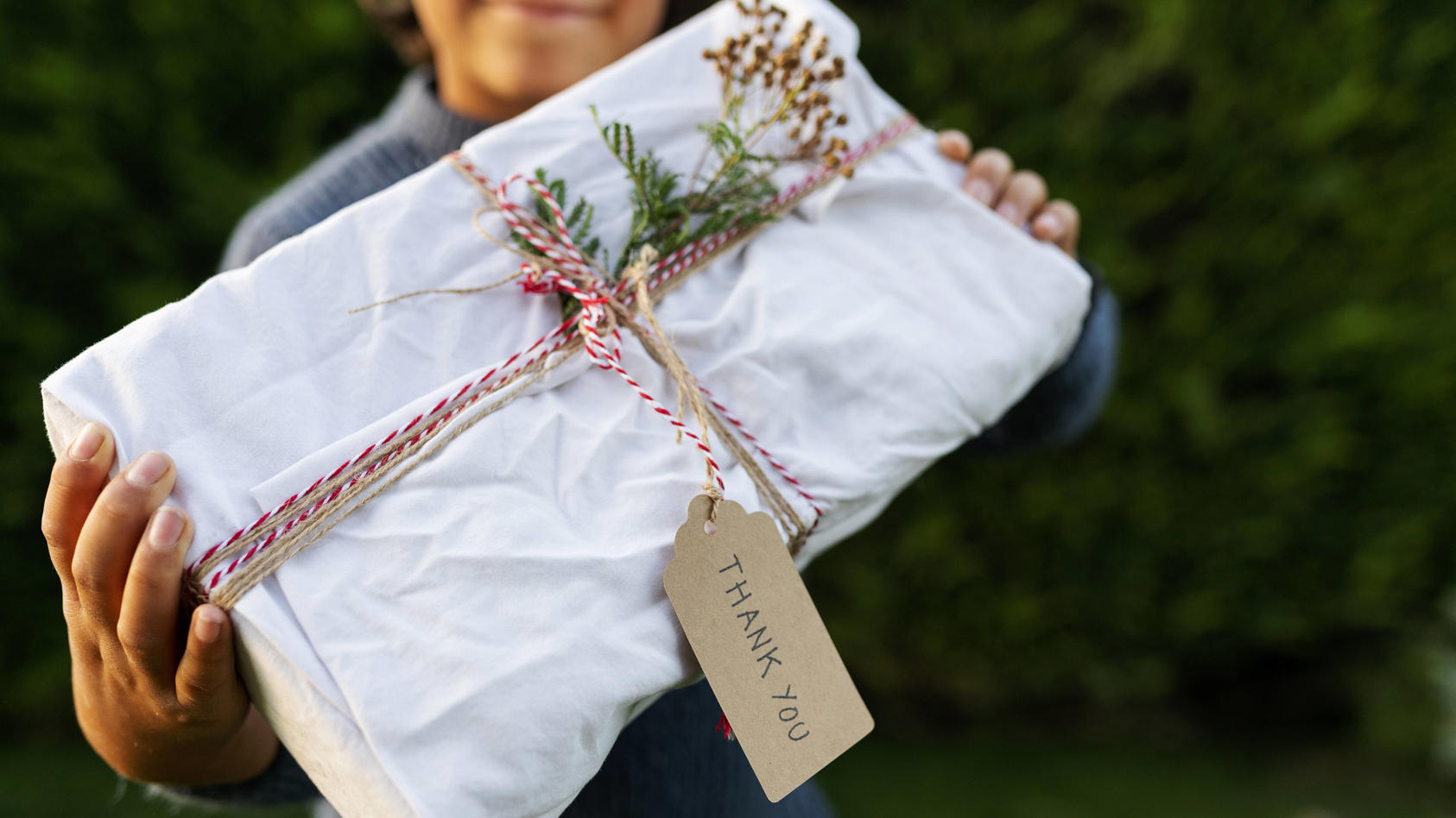 Close-up of boy holding Christmas present in yard model released Symbolfoto VABF03461