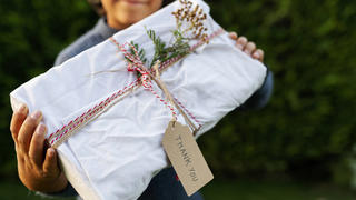  Close-up of boy holding Christmas present in yard model released Symbolfoto VABF03461