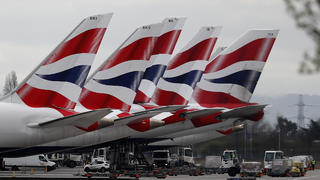 FILE - In this Wednesday, March 18, 2020 file photo, British Airways planes parked at Terminal 5 Heathrow airport in London. British Airwaysâ€™ parent company said Thursday, Sept. 10, 2020 it is to cut flights due to coronavirus travel restrictions and quarantine requirements and confirmed that it is raising 2.7 billion euros ($3.2 billion) through the sale of new shares. (AP Photo/Frank Augstein, File)