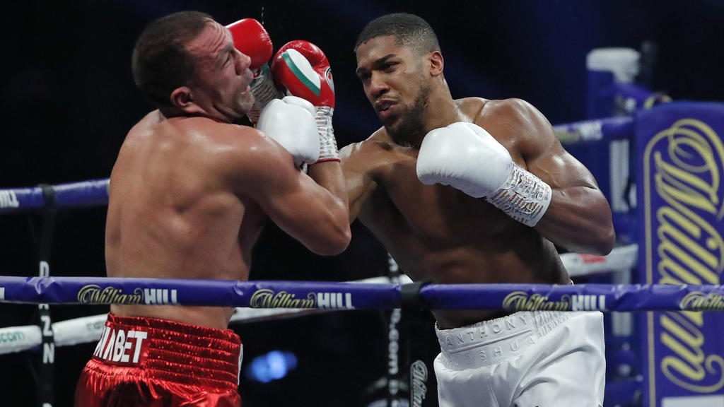 World Heavyweight boxing champion Britain's Anthony Joshua lands a blow on challenger Bulgaria's Kubrat Pulev during their Heavyweight title fight at Wembley Arena in London Saturday, Dec. 12, 2020. (Andrew Couldridge/Pool via AP)