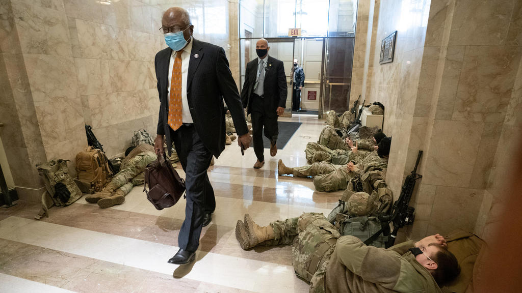 House Majority Whip James Clyburn walks past sleeping members of the National Guard inside the U.S. Capitol as security is increased ahead of the inauguration of President-elect Joe Biden, in Washington, DC on January 13, 2021. PUBLICATIONxINxGERxSU
