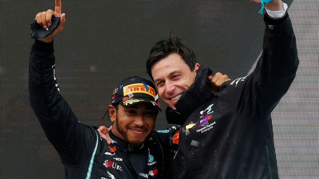 FILE PHOTO: Formula One F1 - Turkish Grand Prix - Istanbul Park, Istanbul, Turkey - November 15, 2020 Mercedes' Lewis Hamilton celebrates on the podium with team principle Toto Wolff after winning the race and the world championship Pool via REUTERS/