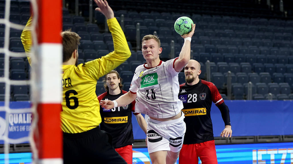 COLOGNE, GERMANY - JANUARY 10: Timo Kastening of Germany (R) scores a goal against Florian Kaiper of Austria (L) during the Handball EURO Qualification match between Germany and Austria at Lanxess Arena on January 10, 2021 in Cologne, Germany. (Photo