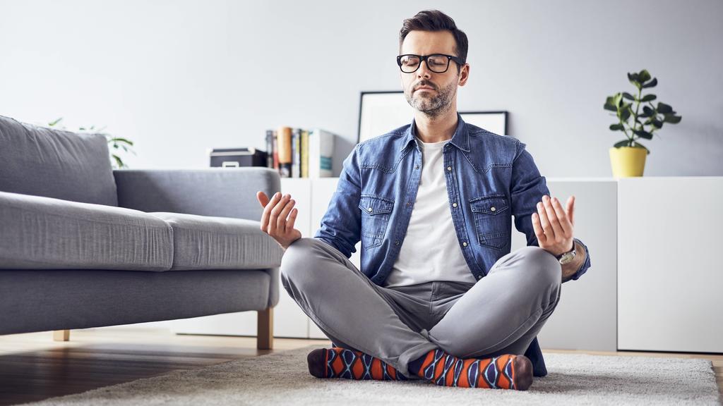 Relaxed man meditating at home model released Symbolfoto property released PUBLICATIONxINxGERxSUIxAUTxHUNxONLY BSZF00303