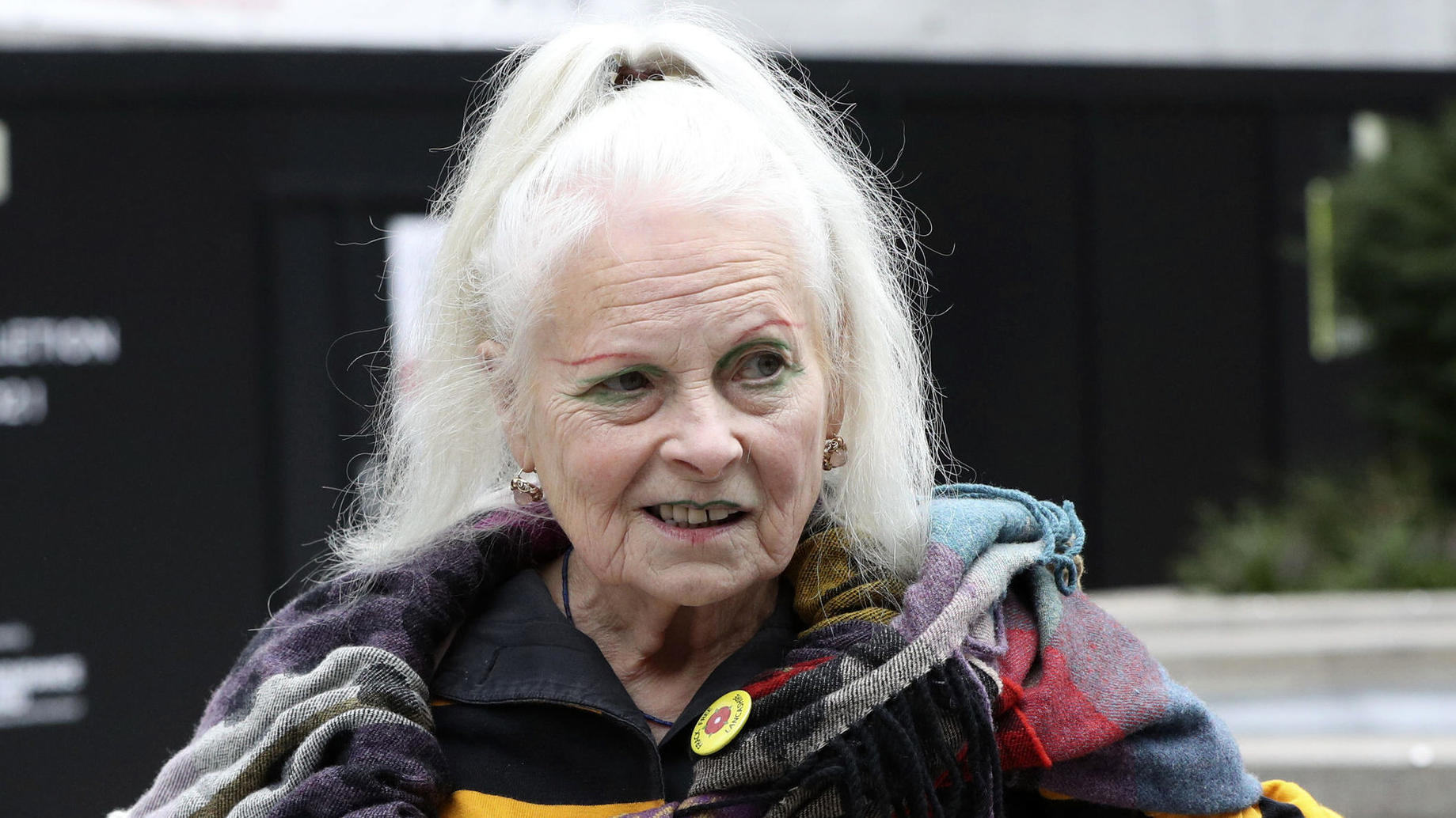 British designer Vivienne Westwood holds a ball with the writing Justice on it as she arrives at a London Court ahead of a hearing on the extradition to the United States of Wikileaks founder Julian Assange, in London, Monday, Sept. 7, 2020. Lawyers 
