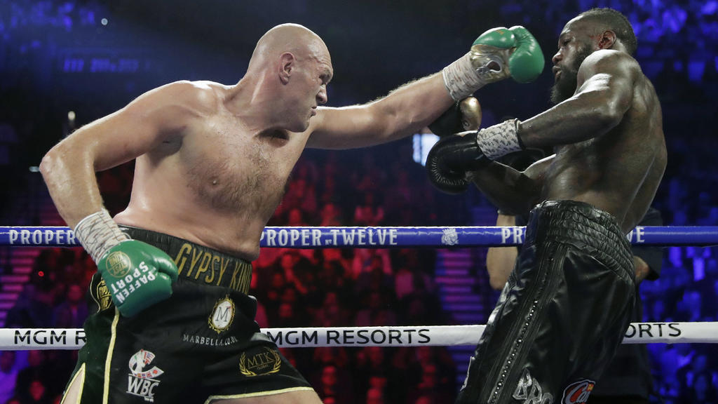 FILE - In this Feb. 22, 2020, file photo, Tyson Fury, left, of England, fights Deontay Wilder during a WBC heavyweight championship boxing match in Las Vegas. Fury is turning his attention to an all-British heavyweight unification bout with Anthony J