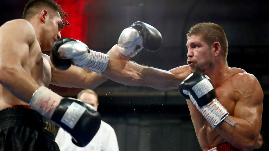 BERLIN, GERMANY - AUGUST 28: Vincent Feigenbutz (R) of Germany exchanges punches with Jama Saidi of Germany during their IBF Interconti Middleweight title fight between Vincent Feigenbutz and Jama Saidi during the AGON Fight Night at Havelstudios on