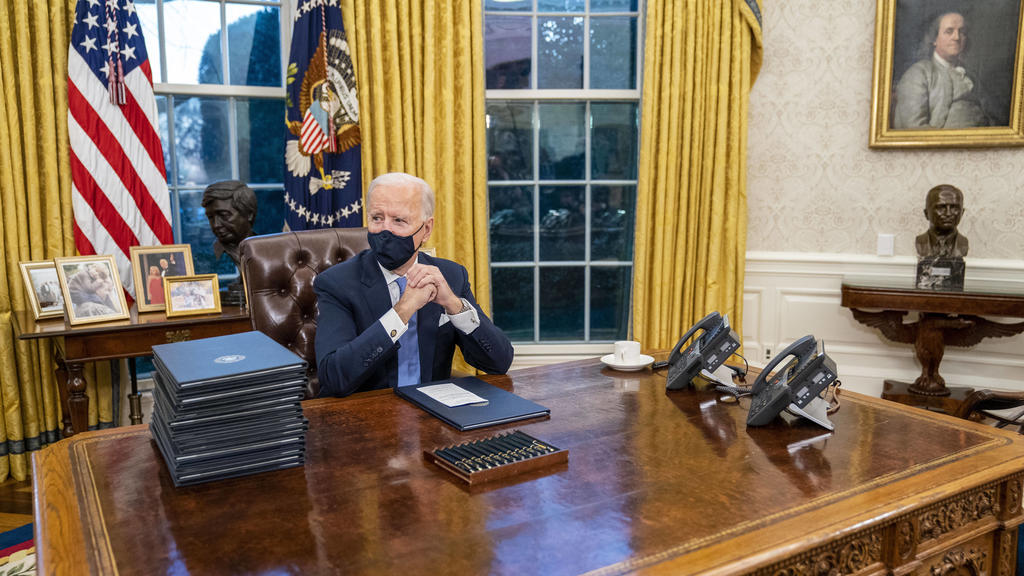 January 20, 2021, Washington, District of Columbia, USA: United States President Joe Biden signs executive order on Covid-19 during his first minutes in the Oval Office, Wednesday, Jan. 20, 2021. President Biden as the 46th president of the United S