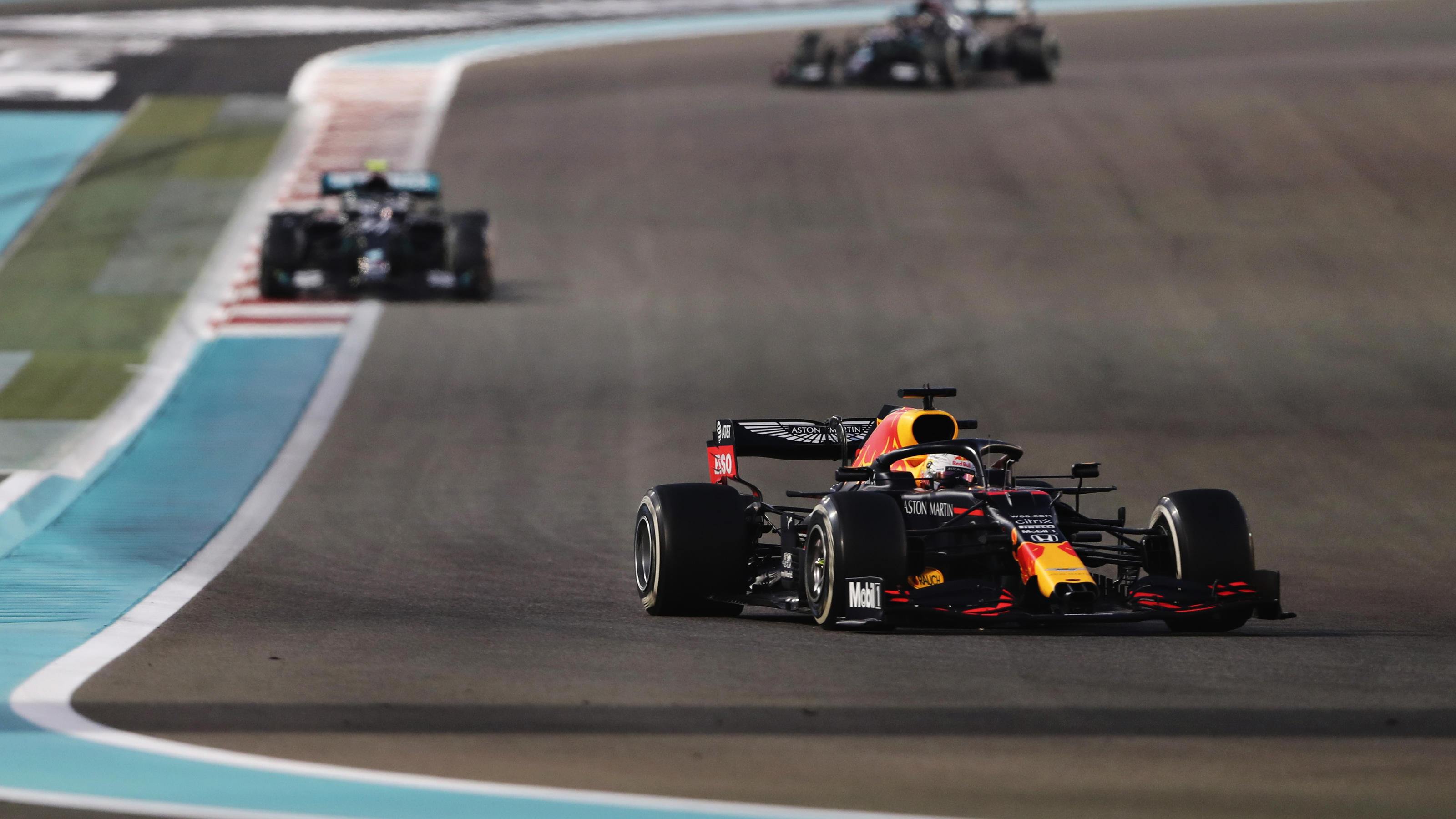 ABU DHABI, UNITED ARAB EMIRATES - DECEMBER 13: Max Verstappen of the Netherlands driving the (33) Aston Martin Red Bull Racing RB16 leads Valtteri Bottas of Finland driving the (77) Mercedes AMG Petronas F1 Team Mercedes W11 during the F1 Grand Prix 