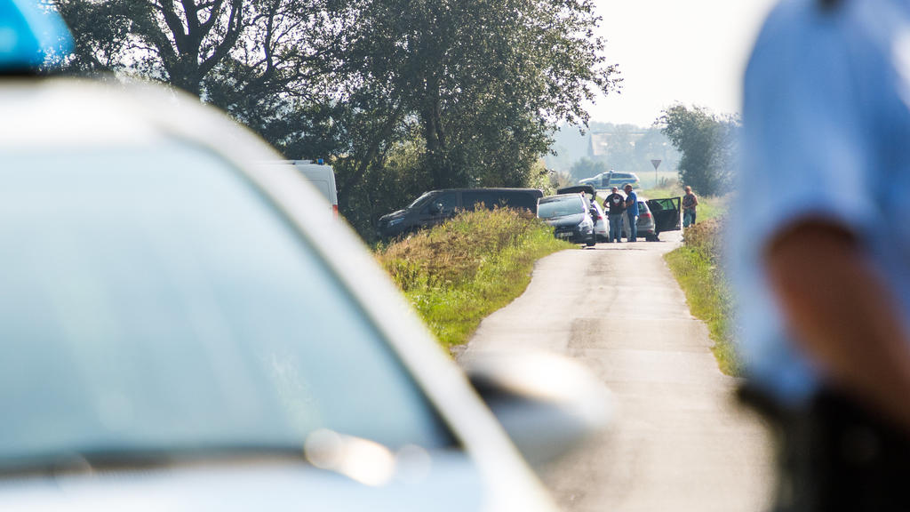 ARCHIV - 31.08.2019, Schleswig-Holstein, Stadum: Ein Polizist steht neben einem Polizeifahrzeug am Anfang einer kleinen Verbindungsstraße, die zu einer Stelle führt, an der ein Polizeieinsatz im Zusammenhang mit der vermissten 23-jährigen Nathalie au