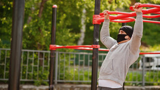 Sportler trainiert in Outdoor-Fitness-Bereich