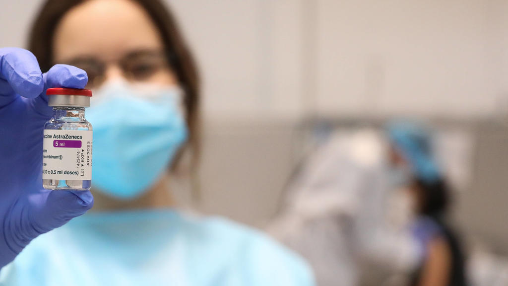 A health professional holds a vial with the vaccine against COVID-19 from AstraZeneca, in the Pavilion 3 of the Public Hospital Enfermera Isabel Zendal, in Madrid, Spain, on February 23, 2021. This Tuesday begins the vaccination in the pavilion 3 of