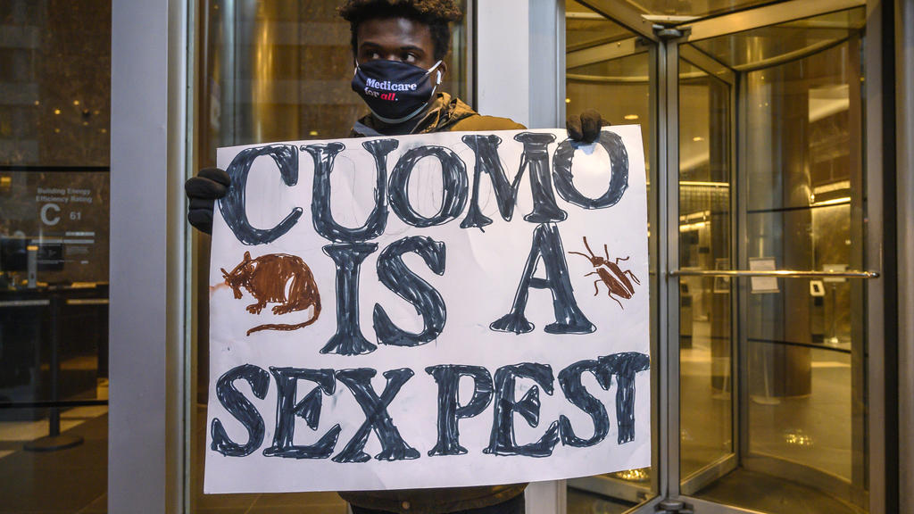 Isaiah Dawson, 22, and other demonstrators rally for New York Gov. Andrew Cuomo's resignation in front of his Manhattan office in New York, Tuesday, March 2, 2021. Cuomo has avoided public appearances for days as some members of his own party call fo