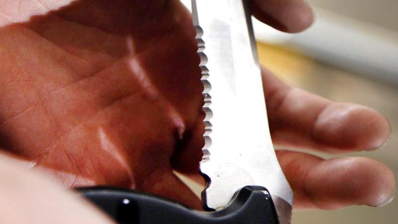 Eine Person hält ein Klappmesser