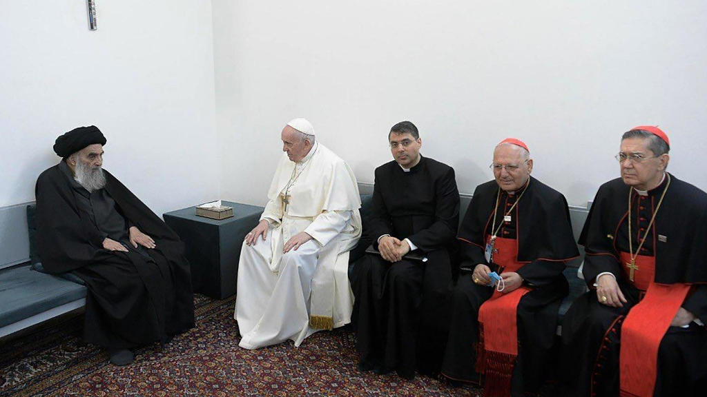 06.03.2021, Irak, Najaf: Papst Franziskus (2.v.r) unterhält sich mit dem Großajatollah Ali al-Sistani (l), zusammen mit christlichen Priestern. Papst Franziskus hat am zweiten Tag seiner Reise den höchsten schiitischen Geistlichen im Irak, Großajatol