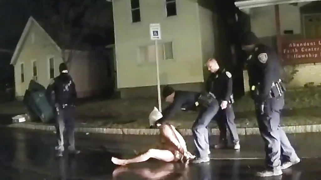 FILE - In this image taken from police body camera video provided by Roth and Roth LLP on Sept. 2, 2020, a Rochester police officer puts a "spit hood" over the head of Daniel Prude, on March 23, 2020, in Rochester, N.Y. The independent investigator l