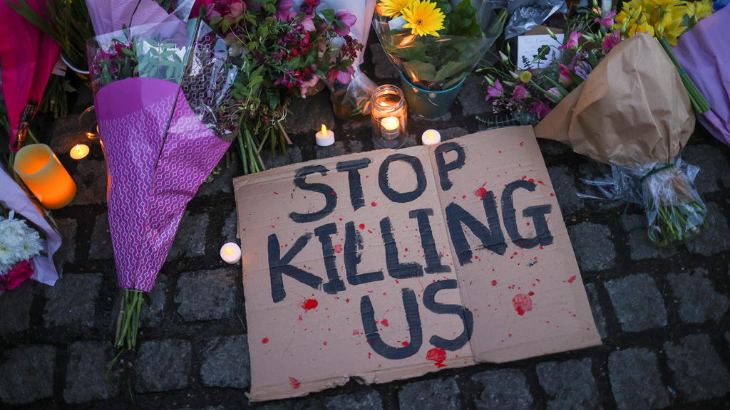 A sign is seen at a memorial site in Clapham Common Bandstand, following the kidnap and murder of Sarah Everard, in London, Britain March 13, 2021. REUTERS/Hannah McKay