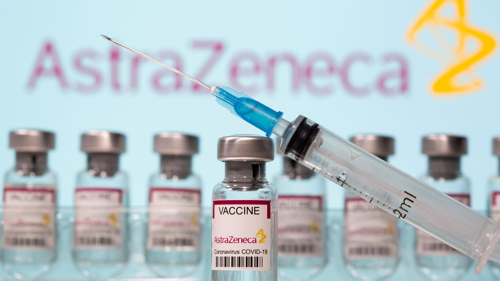 FILE PHOTO: Vials labelled "AstraZeneca COVID-19 Coronavirus Vaccine" and a syringe in front of an AstraZeneca logo in this illustration taken March 10, 2021. REUTERS/Dado Ruvic/Illustration/File Photo