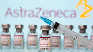 FILE PHOTO: Vials labelled "AstraZeneca COVID-19 Coronavirus Vaccine" and a syringe in front of an AstraZeneca logo in this illustration taken March 10, 2021. REUTERS/Dado Ruvic/Illustration/File Photo