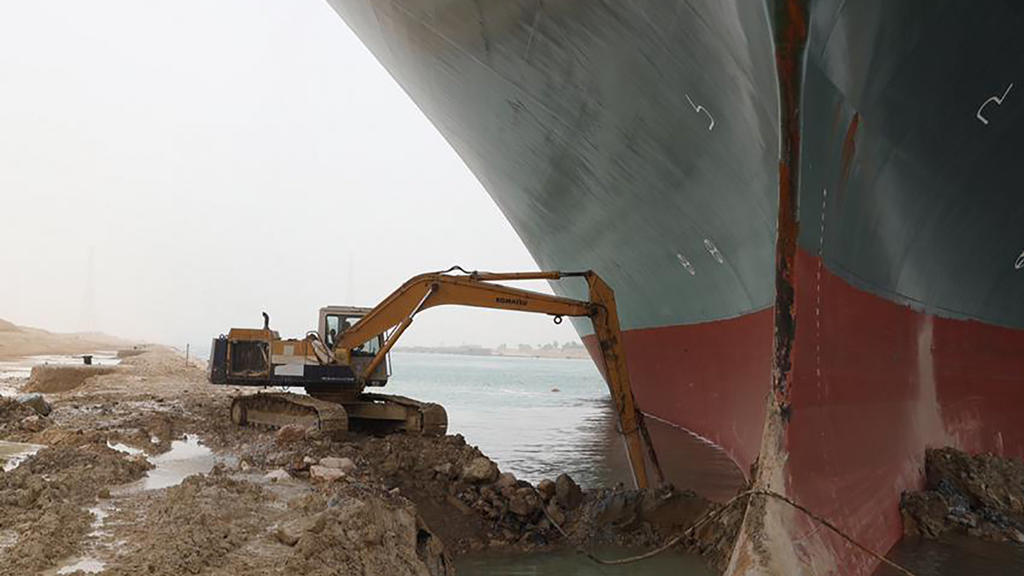 REMOVES REFERENCE TO BACKHOE - A work crew using excavating equipment tries to dig out the Ever Given, a Panama-flagged cargo ship, that is wedged across the Suez Canal and blocking traffic in the vital waterway. An operation is underway to try to w